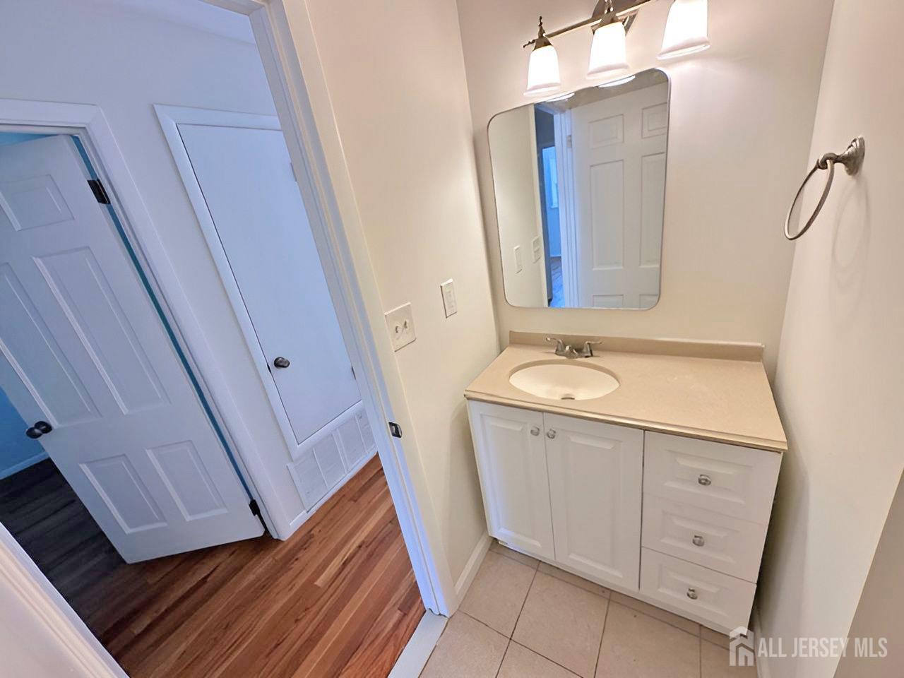 12 Ziff Lane West Windsor, NJ 08550 - Photo 10 of 19 a bathroom with a sink a mirror and a vanity