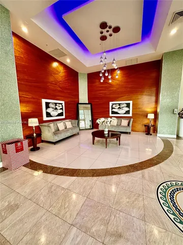 a lobby with furniture and screen