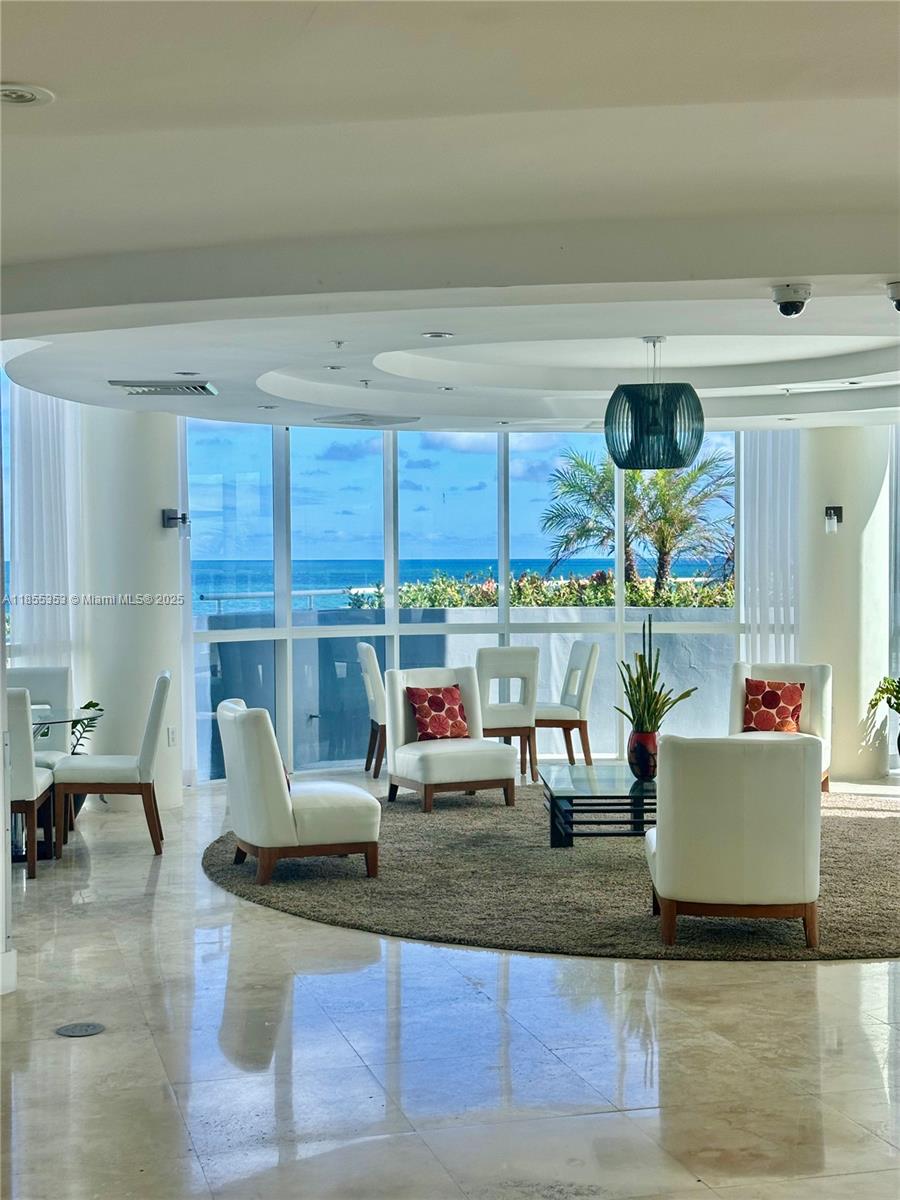 6301 Collins Avenue, Unit 806 Miami Beach, FL 33141 - Photo 22 of 26 a living room with furniture and a floor to ceiling window