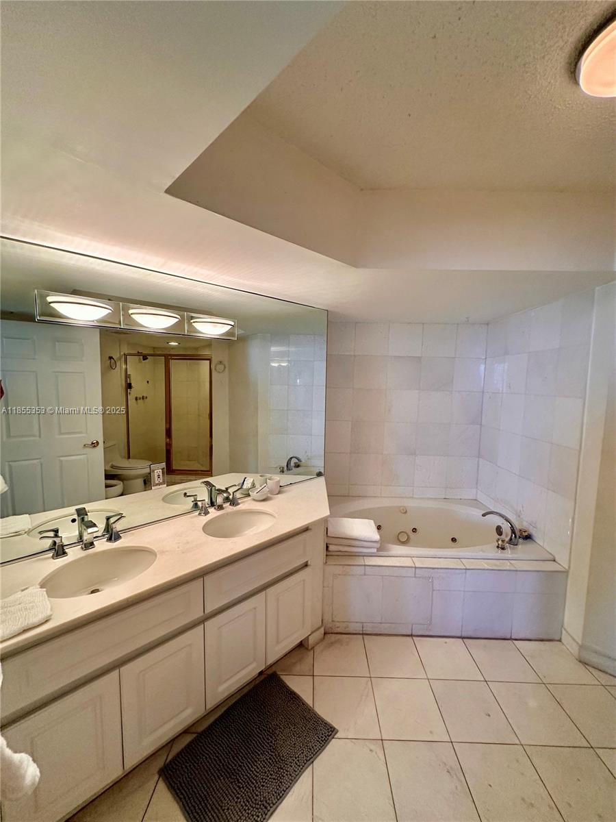 6301 Collins Avenue, Unit 806 Miami Beach, FL 33141 - Photo 9 of 26 a bathroom with a tub sink and mirror