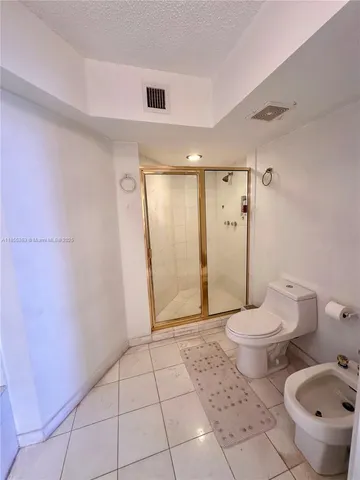 a bathroom with a toilet a sink and shower