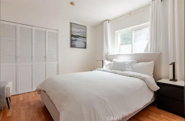 a bedroom with a bed and a window