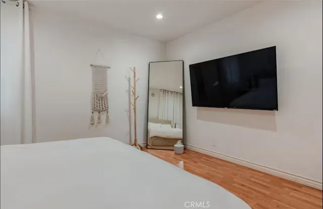 a bedroom with a bed and a flat screen tv