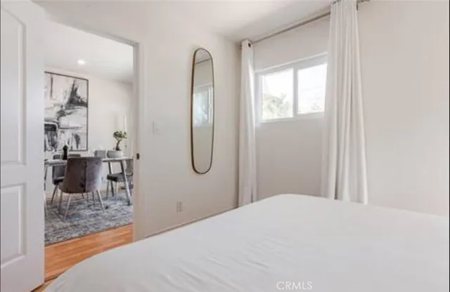 a bedroom with a bed and a chandelier