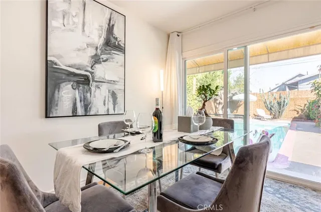 a view of a dining room with furniture large windows and wooden floor