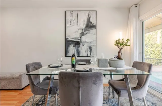 a dining room with furniture and wooden floor