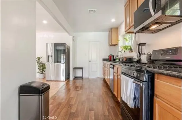 a kitchen with stainless steel appliances granite countertop a stove and a refrigerator