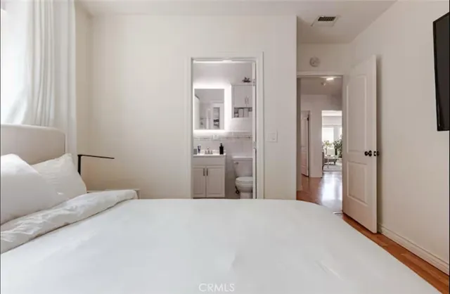 a bedroom with a bed and glass door