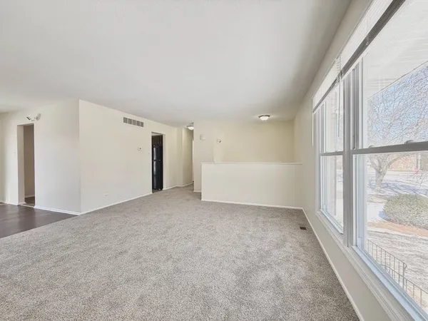 a view of an empty room with a window