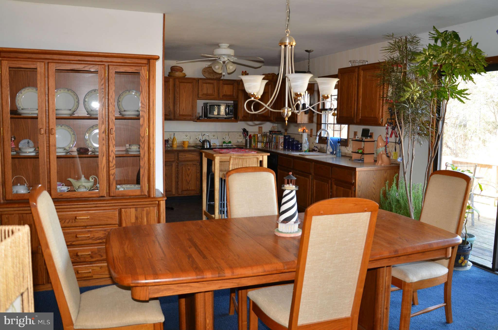 103 Parks Road Chester, MD 21619 - Photo 12 of 25 a dining room with furniture a chandelier and window