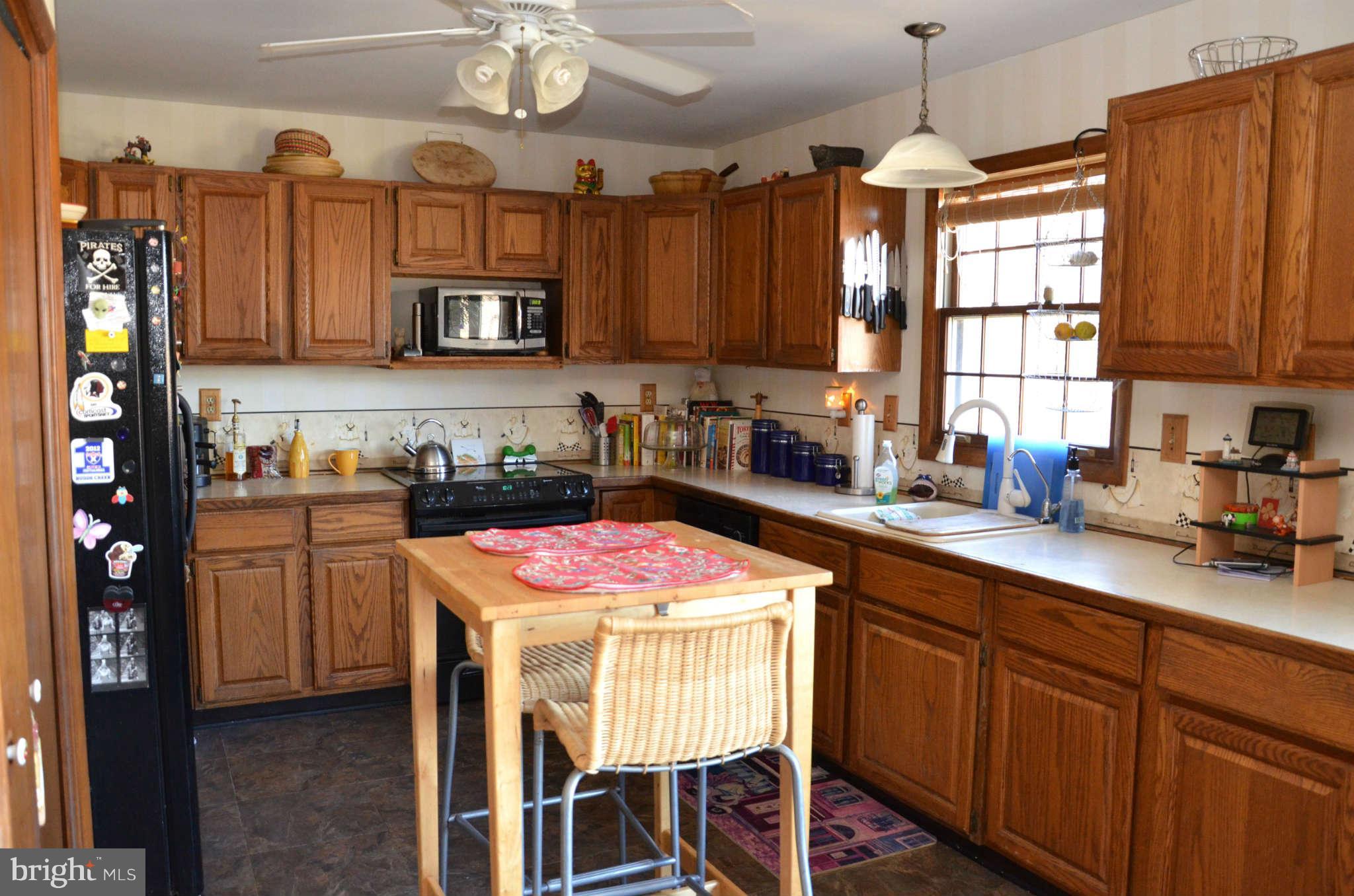 103 Parks Road Chester, MD 21619 - Photo 14 of 25 a kitchen with stainless steel appliances kitchen island granite countertop a sink stove and cabinets