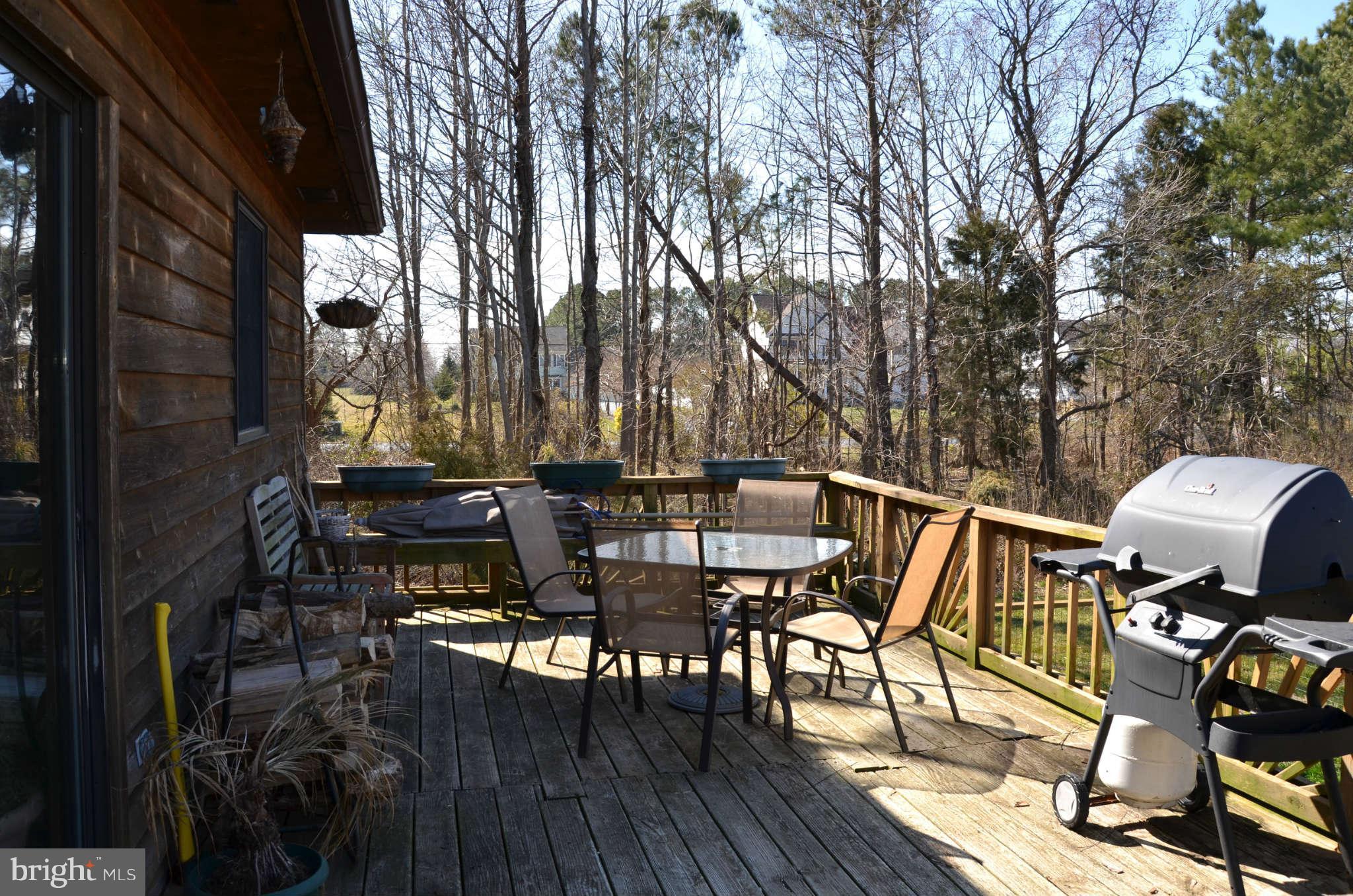 103 Parks Road Chester, MD 21619 - Photo 20 of 25 a view of a patio with table and chairs with wooden floor and fence