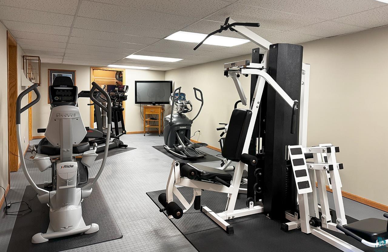 197 Jefferson Street Buhl, MN 55713 - Photo 17 of 31 Exercise area featuring a drop ceiling and baseboards