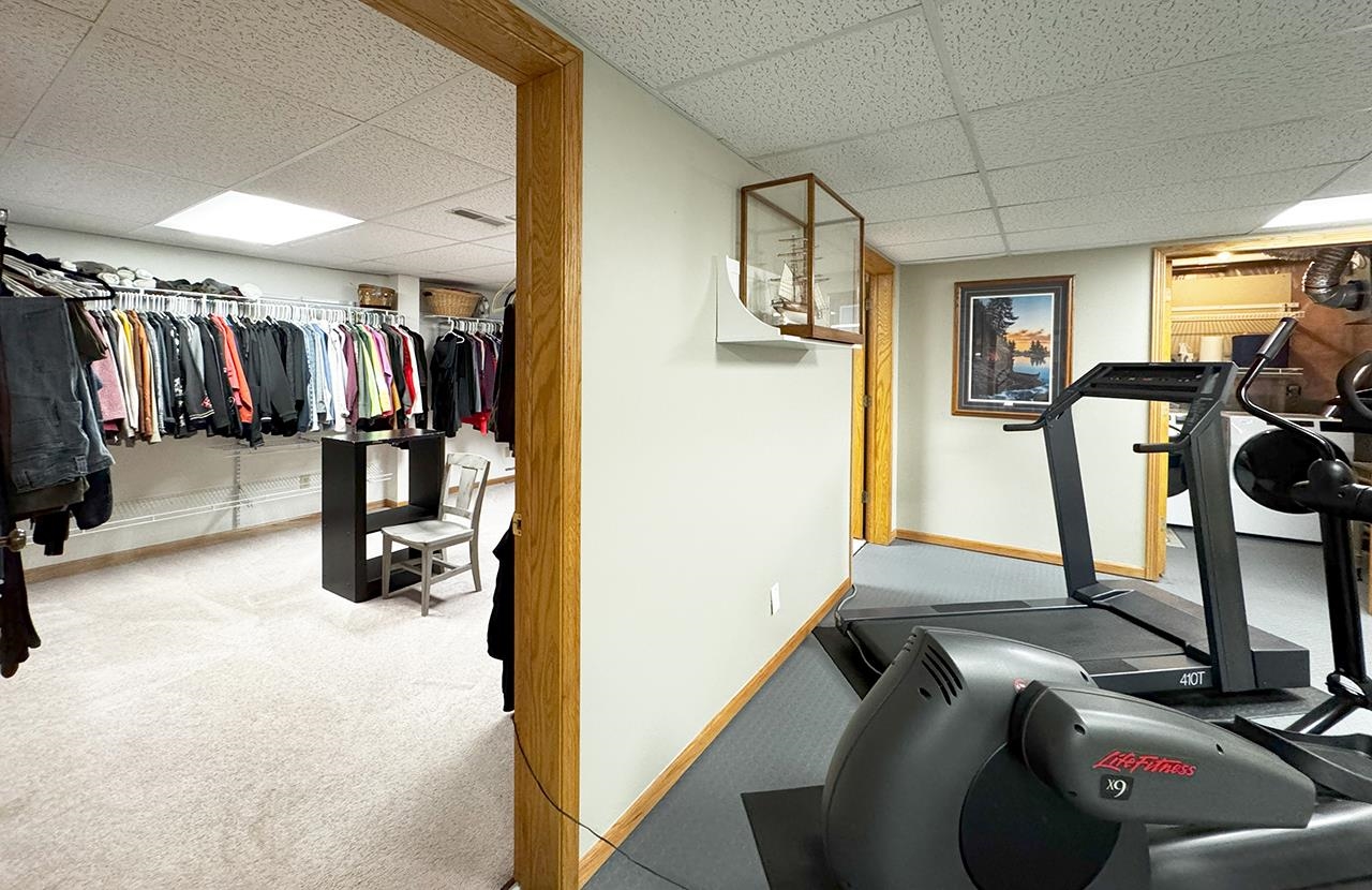 197 Jefferson Street Buhl, MN 55713 - Photo 18 of 31 Workout area featuring a drop ceiling, baseboards, and carpet floors
