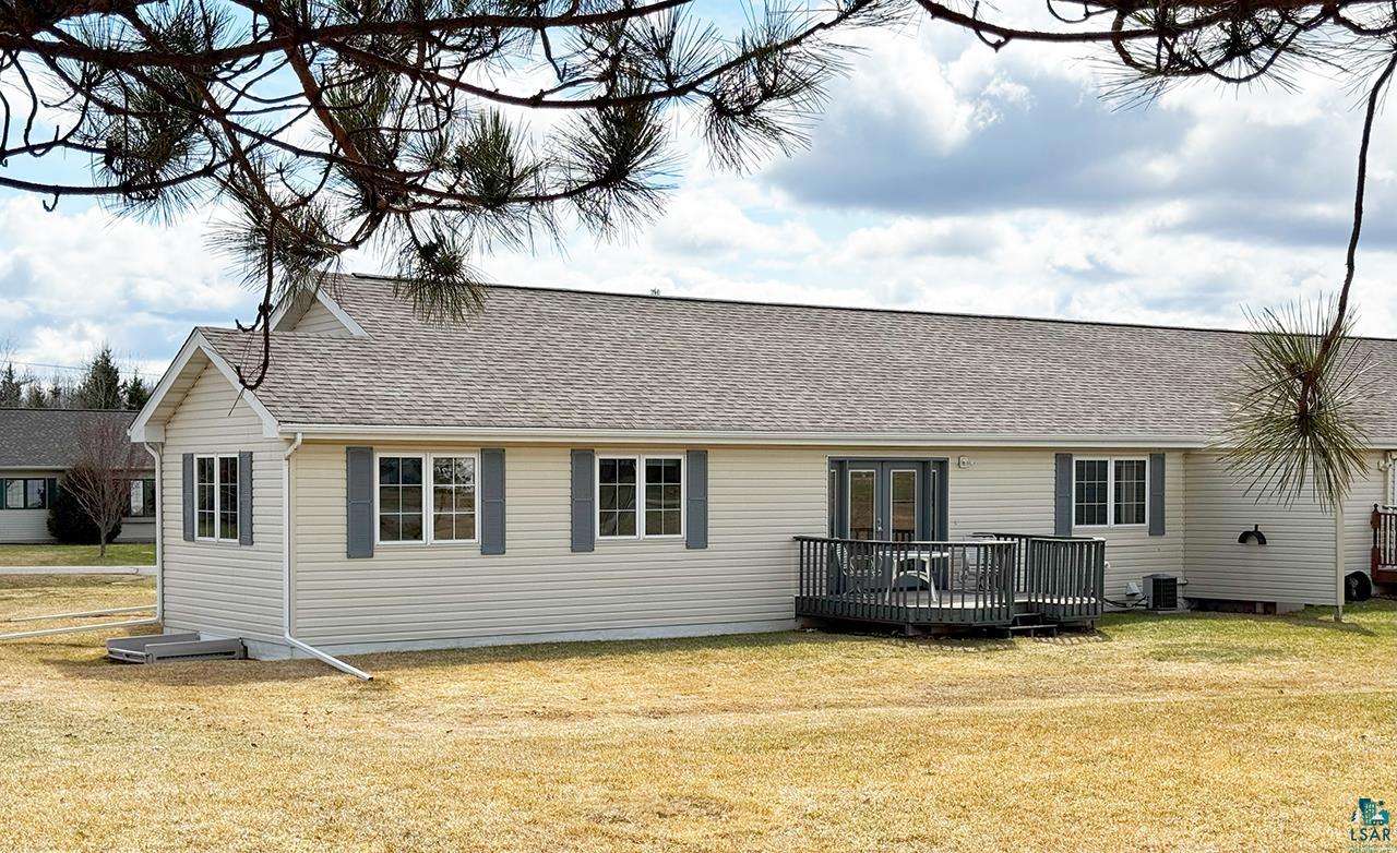 197 Jefferson Street Buhl, MN 55713 - Photo 29 of 31 Back of house with a deck, french doors, a yard, cooling unit, and a shingled roof