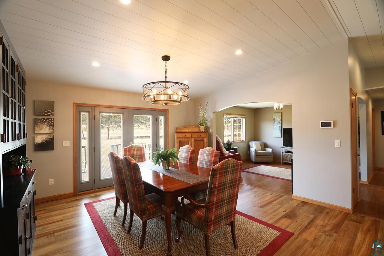 197 Jefferson Street Buhl, MN 55713 - Photo 7 of 31 Dining area with arched walkways, plenty of natural light, light wood-style flooring, a chandelier, and recessed lighting