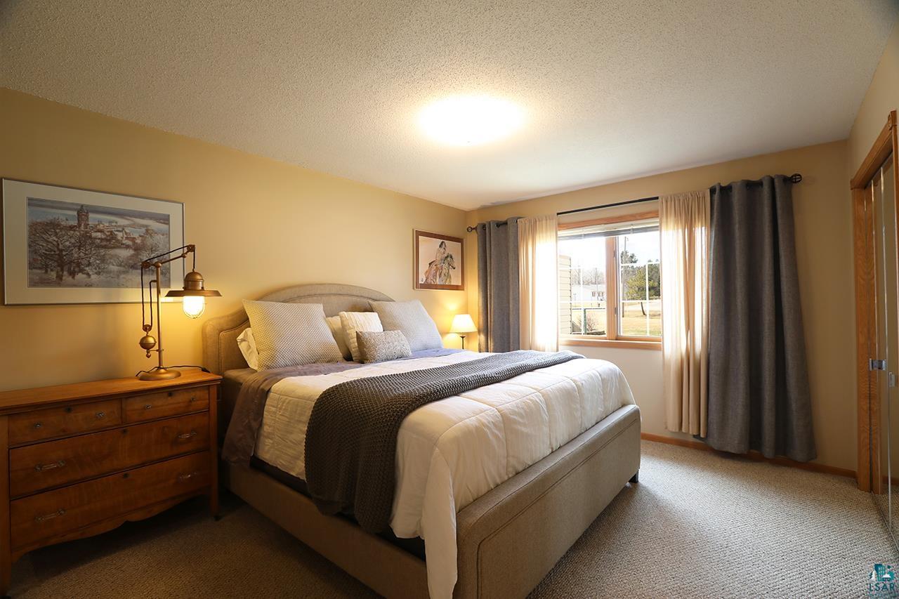 197 Jefferson Street Buhl, MN 55713 - Photo 10 of 31 Bedroom featuring light colored carpet and a textured ceiling