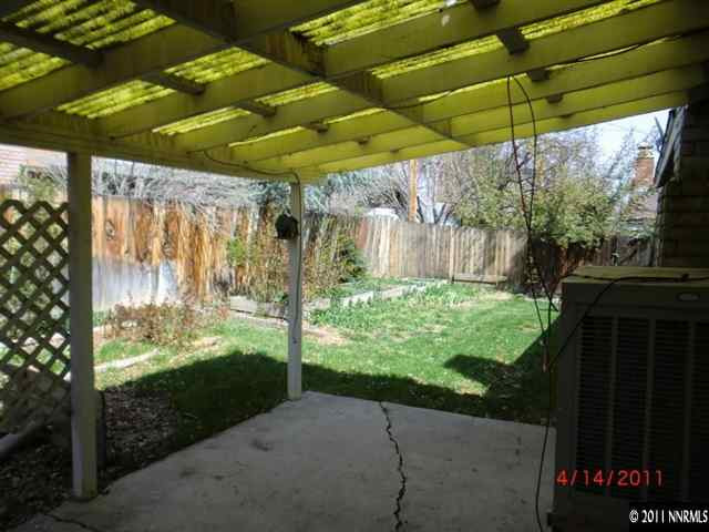 2015 Windsor Way Reno, NV 89503 - Photo 8 of 8 a view of a backyard with table and chairs under an umbrella