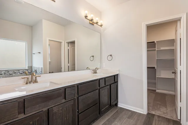 a bathroom with a double vanity sink and a mirror