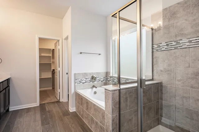 a bathroom with a bathtub and a shower