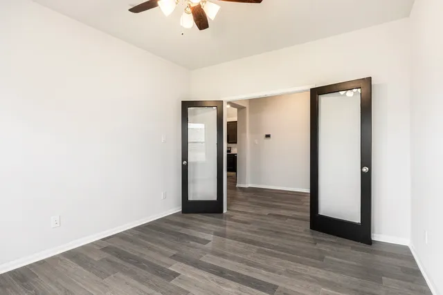 an empty room with wooden floor and closet