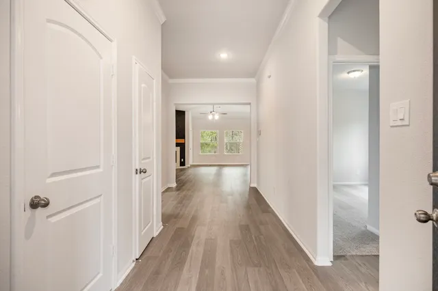 a view of a hallway with wooden floor