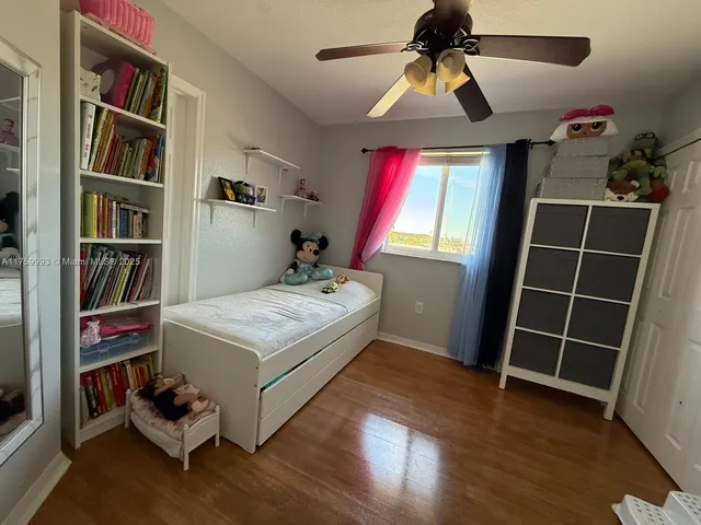 a bedroom with a bed and a book shelf