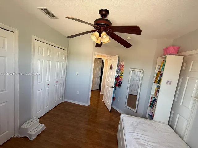 a view of a hallway view with furniture and wooden floor