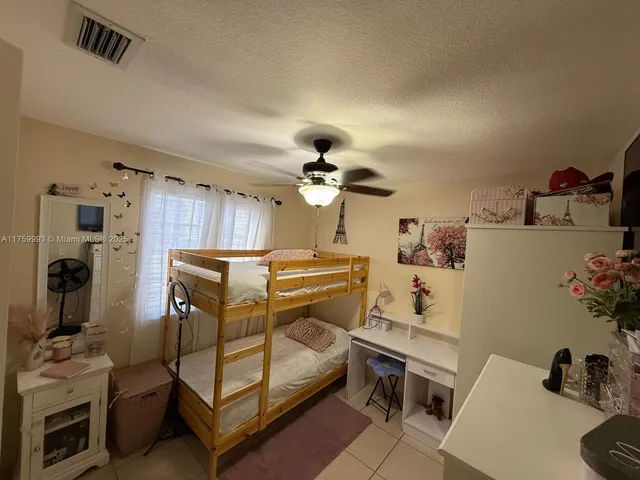 a bedroom with furniture and a chandelier