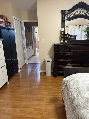 a bedroom with a bed and a mirror