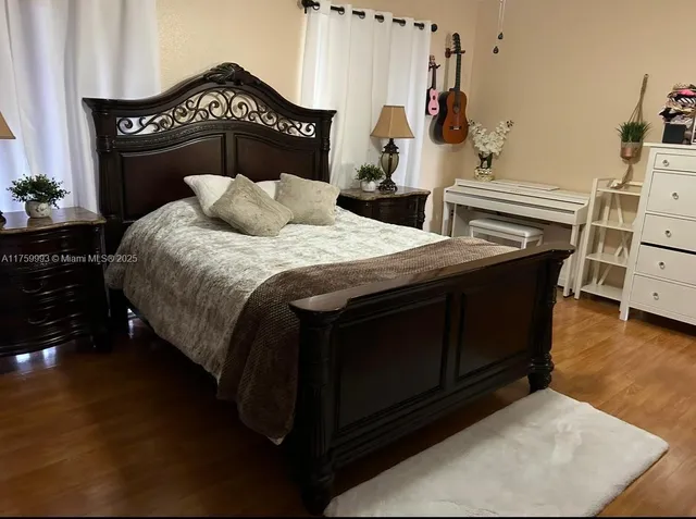 a bedroom with a bed and dresser