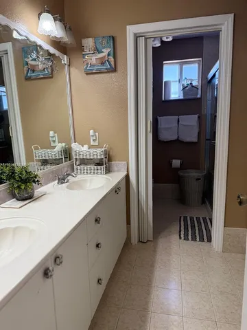 a bathroom with a sink a toilet and a mirror
