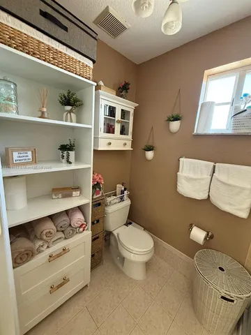 a bathroom with a toilet a sink and a mirror