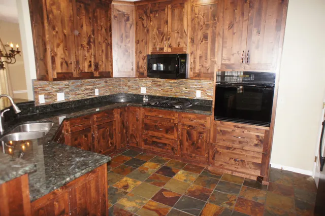a kitchen with granite countertop a sink and a stove