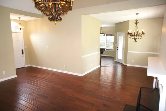a view of livingroom and dining room with wooden floor
