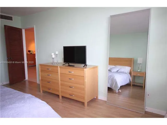 a bed room with a bed and a television