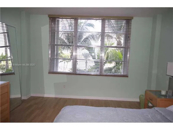 a room with a window and a ceiling fan