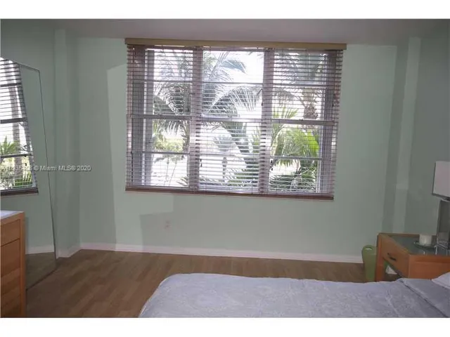 a room with a window and a ceiling fan