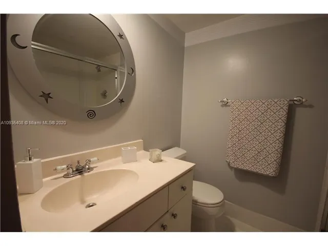a bathroom with a sink toilet and mirror