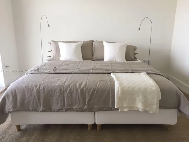 a bedroom with a bed and a night stand