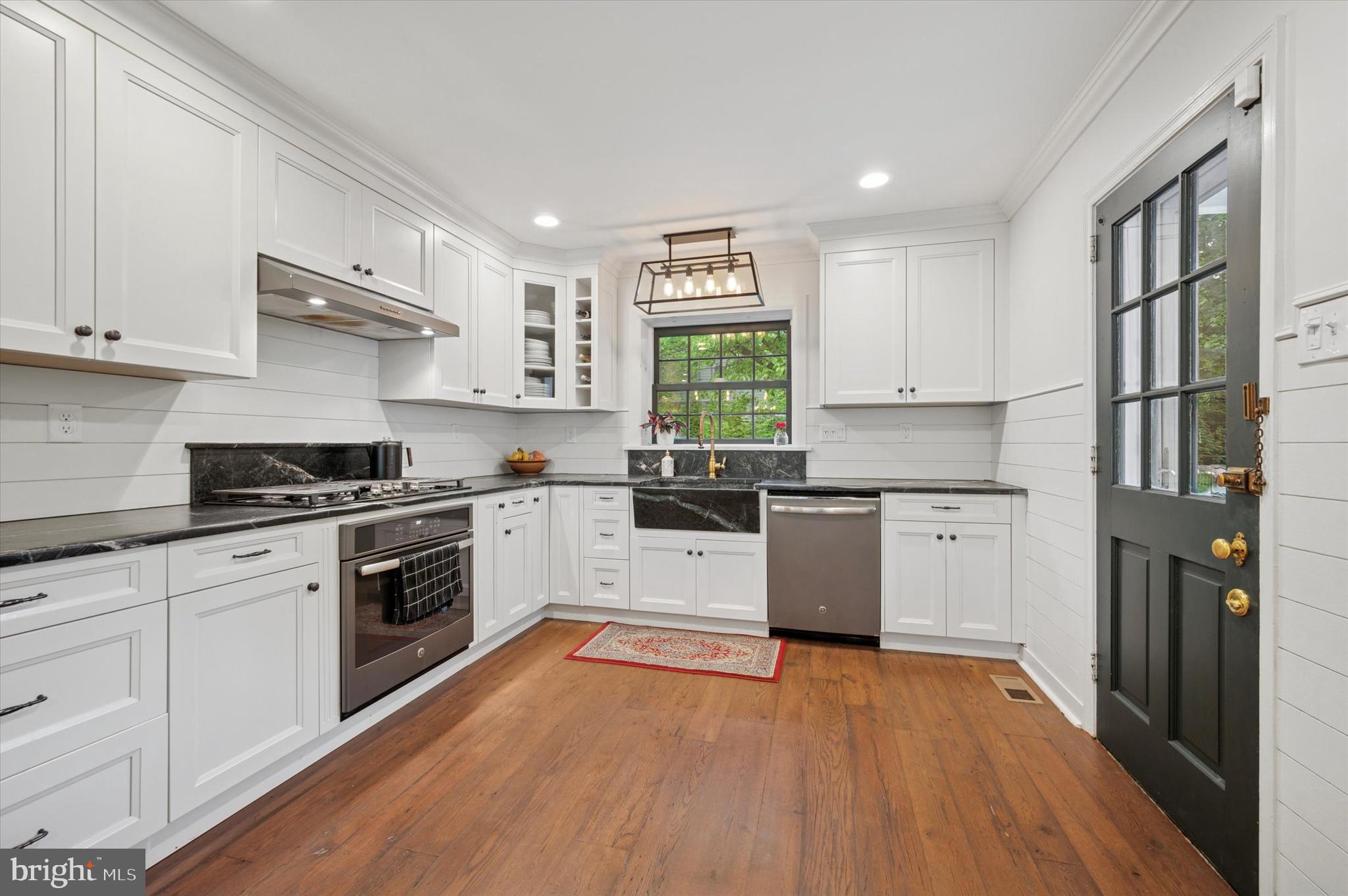 1205 Red Rambler Road Rydal, PA 19046 - Photo 17 of 34 a kitchen with a white cabinets a sink a window and stainless steel appliances