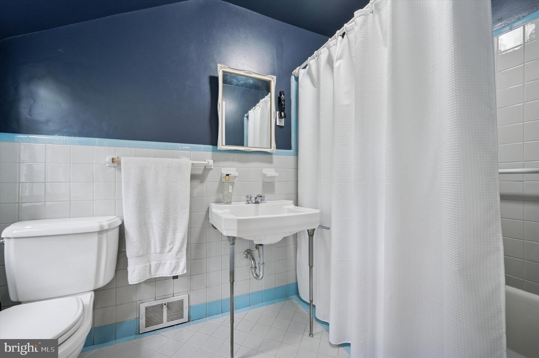 1205 Red Rambler Road Rydal, PA 19046 - Photo 22 of 34 a bathroom with a sink a toilet and a mirror