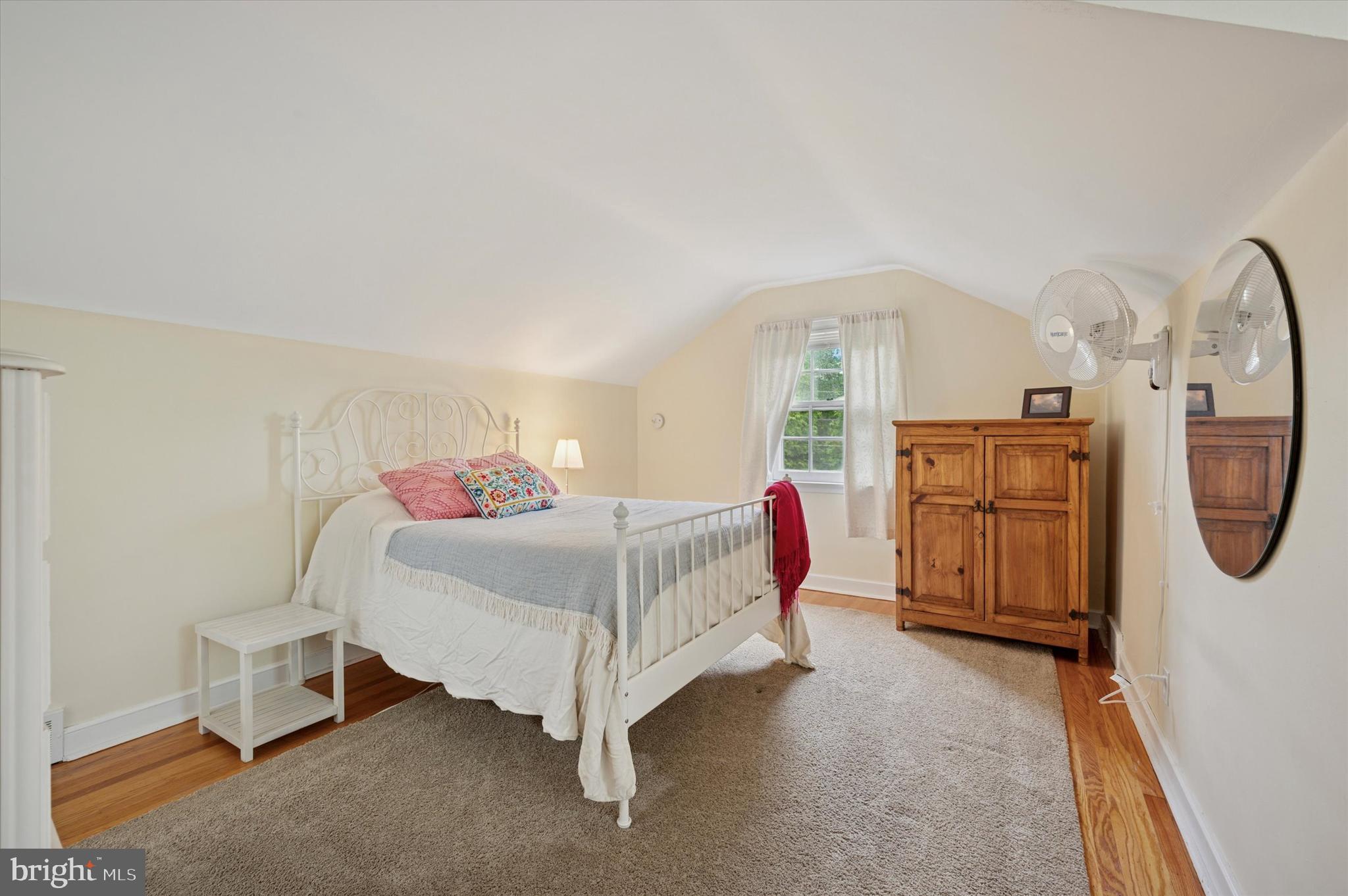 1205 Red Rambler Road Rydal, PA 19046 - Photo 29 of 34 a bedroom with a bed a mirror on dresser and a chandelier