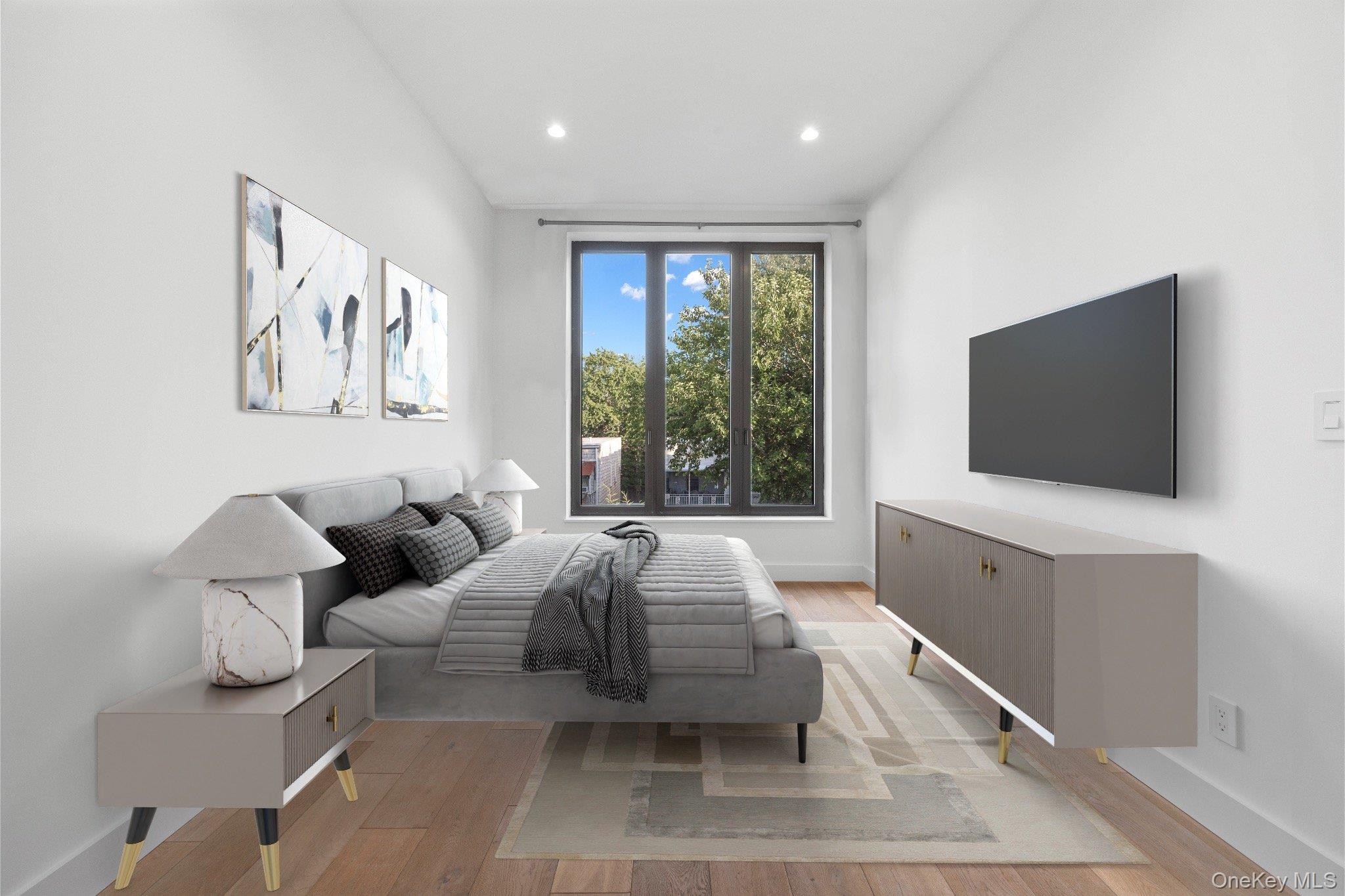 26-33 28th Street, Unit 3B Queens, NY 11102 - Photo 12 of 16 a living room with furniture and a flat screen tv