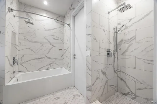 a bathroom with a bathtub and a shower