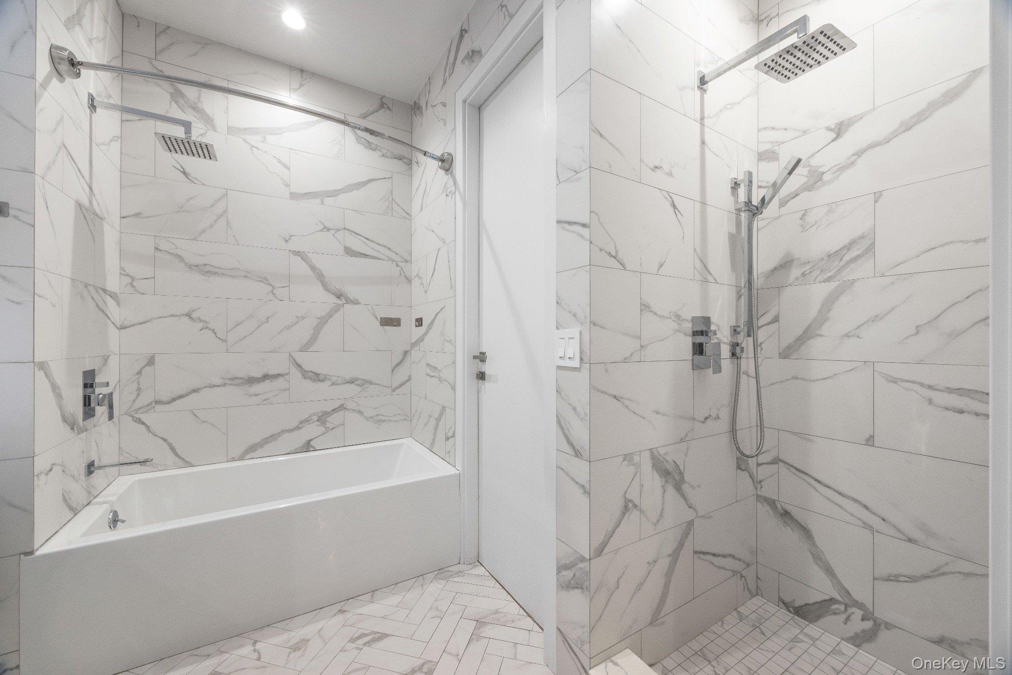 26-33 28th Street, Unit 3B Queens, NY 11102 - Photo 14 of 16 a bathroom with a bathtub and a shower