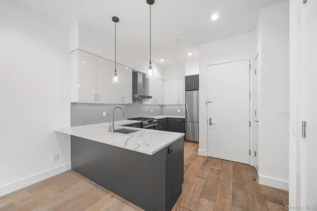 a kitchen with a sink a stove a refrigerator and cabinets