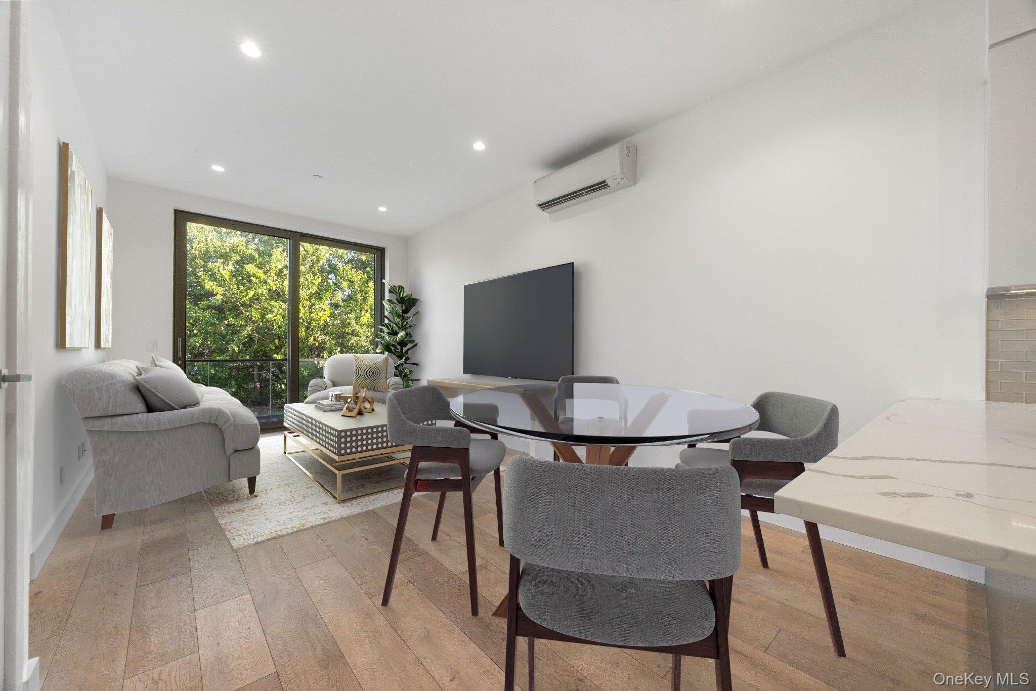 26-33 28th Street, Unit 3B Queens, NY 11102 - Photo 6 of 16 a living room with furniture and a flat screen tv