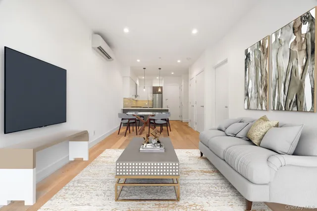 a living room with furniture a rug and a flat screen tv