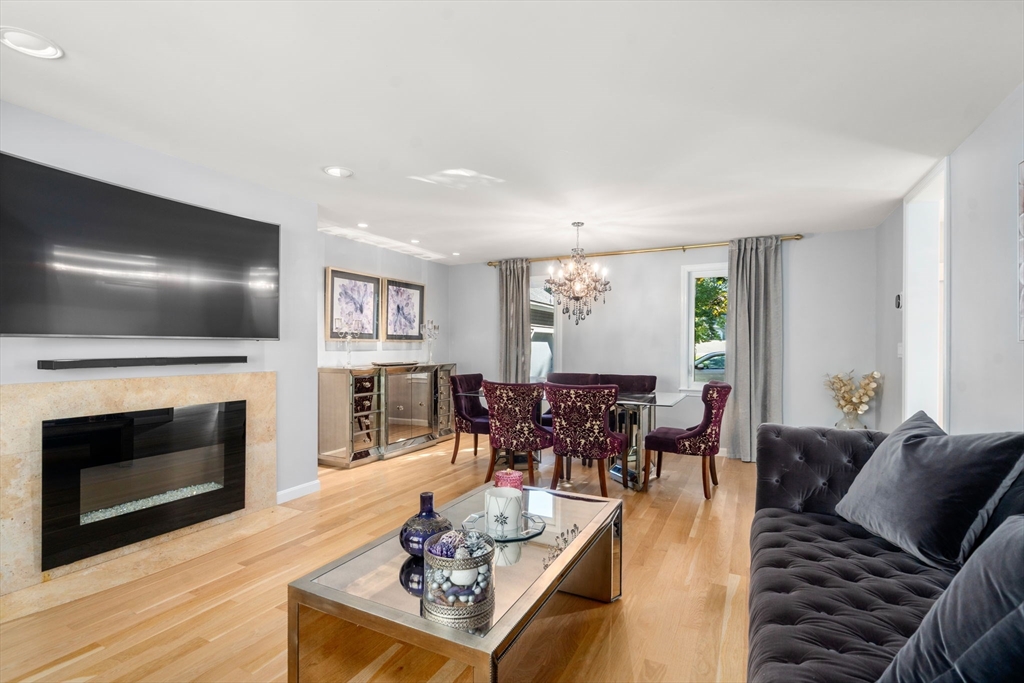 16 Coltsway, Unit 16 Wayland, MA 01778 - Photo 12 of 29 a living room with furniture flat screen tv and a fireplace